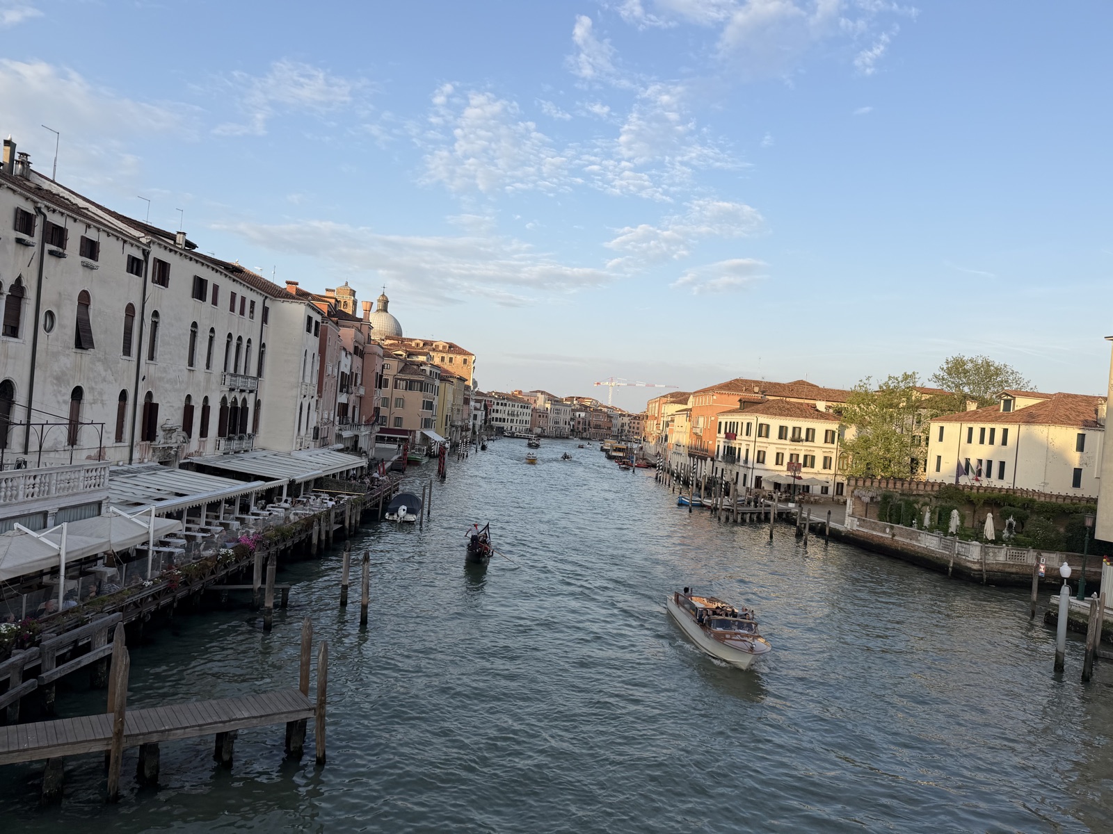 The Grand Canal at golden hour with a vaporetto and a small boat, a slow afternoon view of Venice
